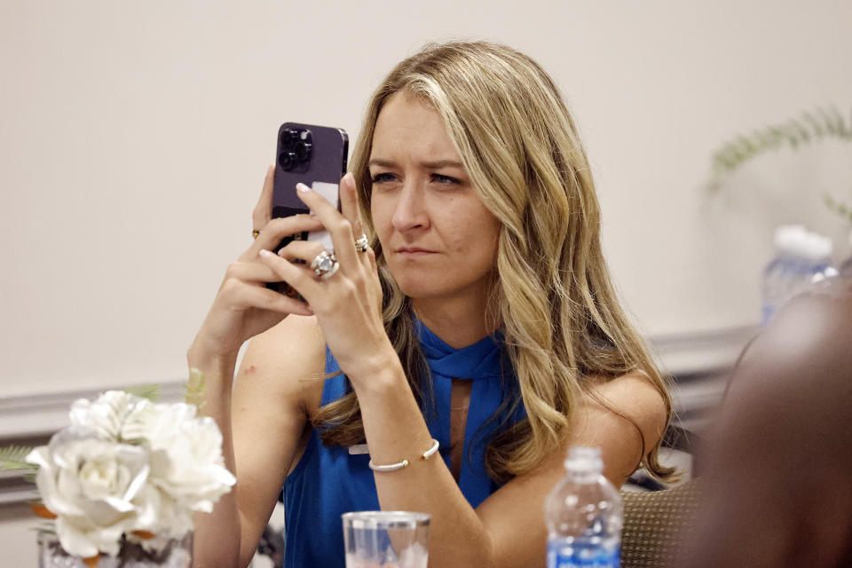 Anderson Clayton, chair of the Democratic Party of North Carolina, records the comments of speakers at a meeting of the Democratic Committee of North Carolina at the Word of Tabernacle Church in Rocky Mount, N.C., Thursday, May 23, 2024. (AP Photo/Karl B, DeBlaker)