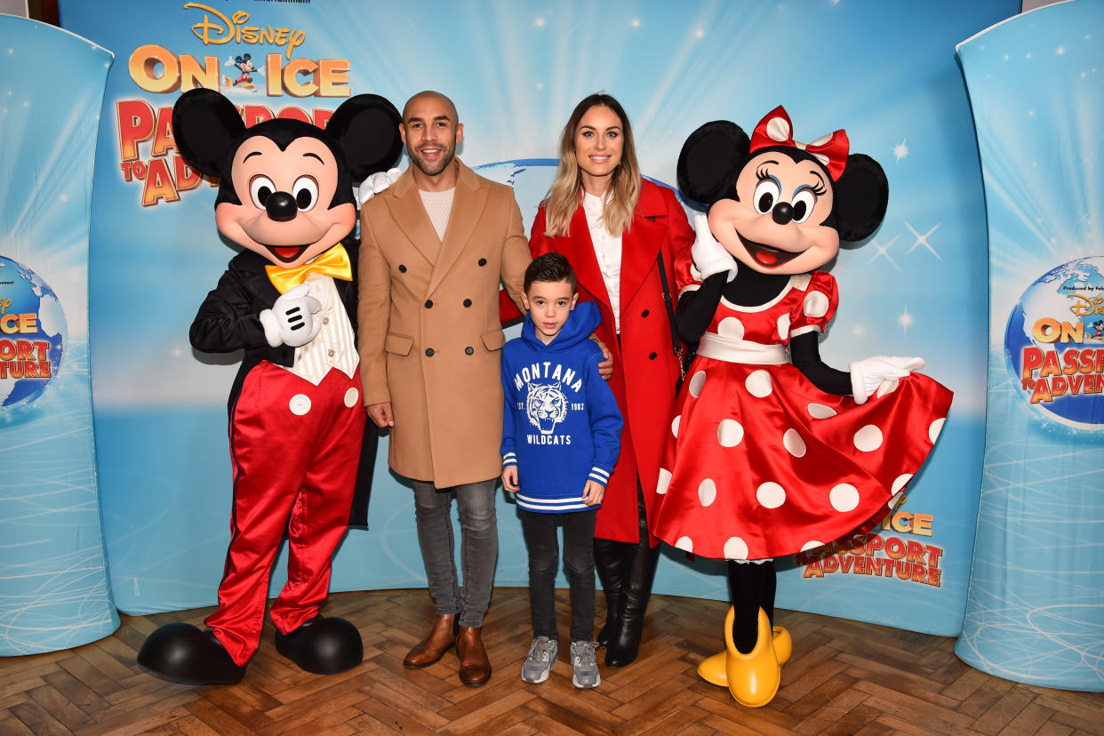 EDITORIAL USE ONLY Alex Beresford, wife Natalie and son Cruz meet Mickey and Minnie Mouse at the opening night of Disney On Ice Passport to Adventure at the O2 Arena from December 20th until December 30th, London.