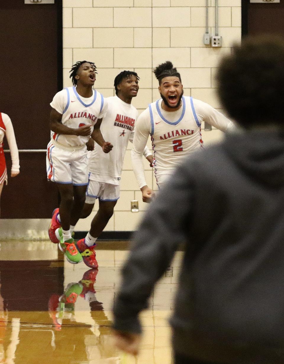 K'Vaughn Davis (2) and teammates react after Davis' 3-pointer to tie the game at the end of regulation against Chaney in a district semifinal Thursday, March 2, 2023, at Boardman High School.