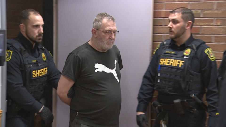 Tony Humby is escorted by sheriff's officers at provincial court in St. John's last June.