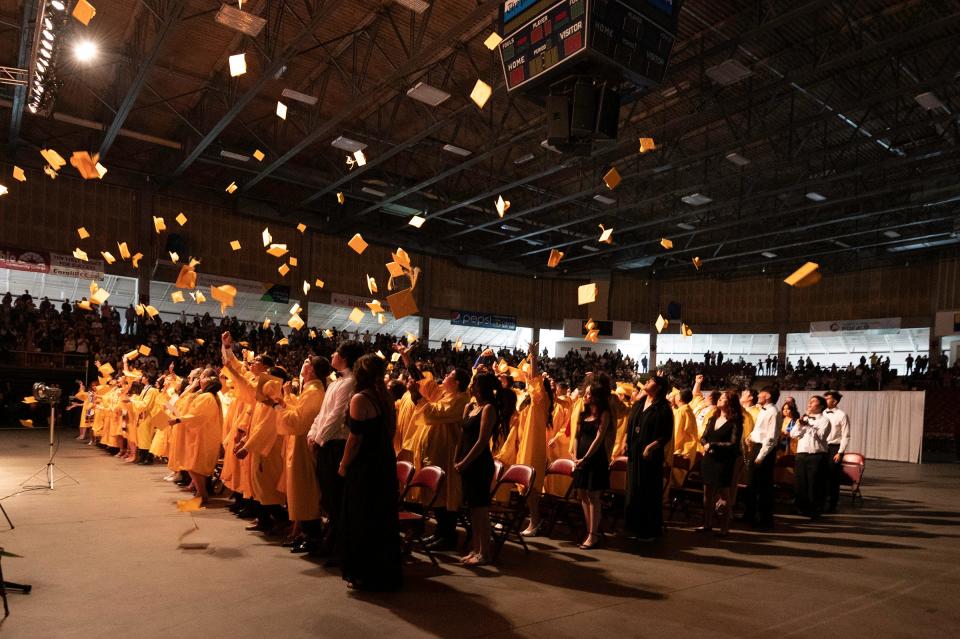 Pueblo East High School graduates toss their caps at the conclusion of their commencement ceremony on Friday, May 26, 2023.