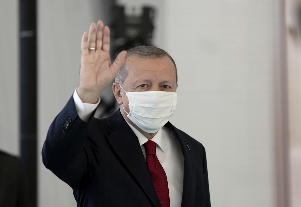 Turkey's President Recep Tayyip Erdogan, wearing a mask for protection against the coronavirus, arrives to inaugurate a new hospital in Istanbul, Friday, May 29, 2020. Worshippers in Turkey have held their first communal Friday prayers in 74 days after the government reopened some mosques as part of its plans to relax measures in place to fight the coronavirus outbreak. The partial opening of the mosques follows a slowdown in the confirmed COVID-19 infections and deaths in the country. (Can Erok/DHA via AP)