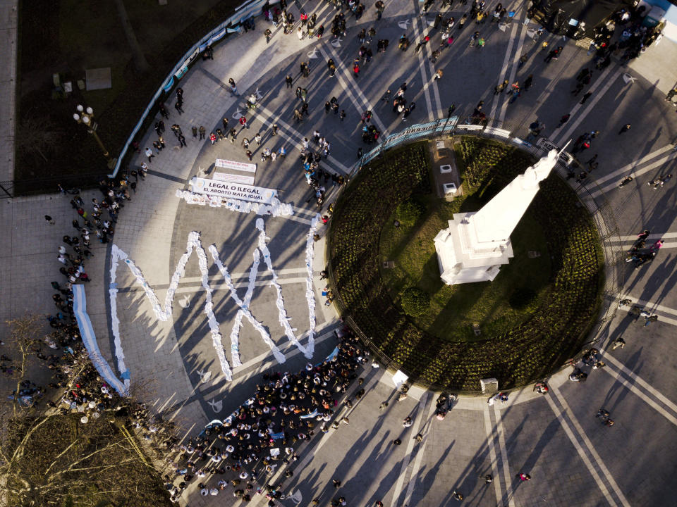 This July 15, 2018 photo shows white medical coats laid out on the pavement in front of the presidential palace forming the letters "MXV", the Spanish acronym for Doctors for Life, at the end of protest march against a campaign to expand legal abortions, in Buenos Aires, Argentina. The Academy of Medicine vehemently rejects the campaign, issuing a statement that states human life begins at conception and "to destroy a human embryo means impeding the birth of a human being." (AP Photo/Jorge Saenz)