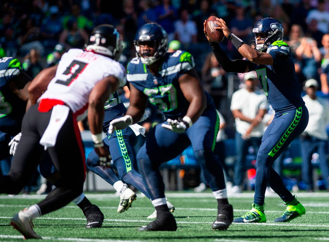 Seattle Seahawks quarterback Geno Smith (7) catches a snap in the first quarter of an NFL game against the Atlanta Falcons at Lumen Field in Seattle, Wash. on Sept. 25, 2022.