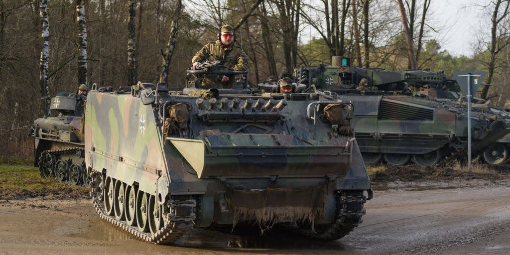 A Bundeswehr M113 armored personnel carrier stands during an exercise at the military training area.