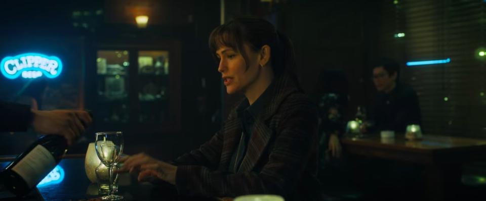 Ellie sitting at a bar in "The Adam Project"