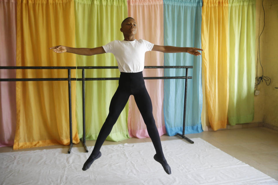 Ballet dancer Anthony Mmesoma Madu rehearses in Lagos, Nigeria on Aug. 18, 2020. Cellphone video showing the 11-year-old dancing barefoot in the rain went viral on social media. Madu’s practice dance session was so impressive that it earned him a ballet scholarship with the American Ballet Theater in the U.S. (AP Photo/Sunday Alamba)