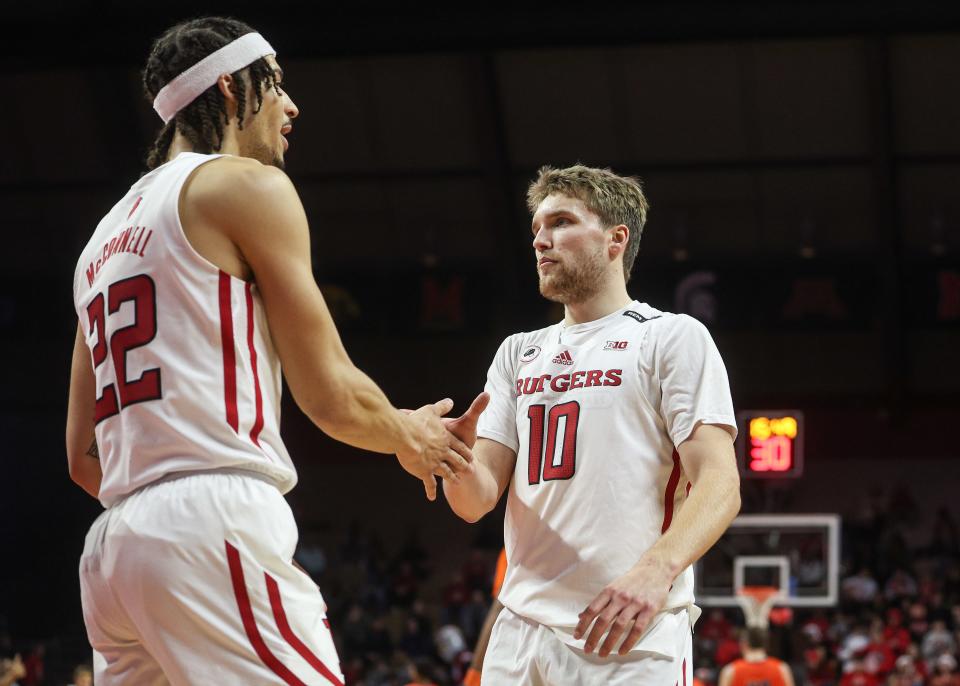 Rutgers Scarlet Knights guard Cam Spencer (10) slaps hands with guard Caleb McConnell (22) during the first half against the Bucknell Bison at Jersey Mike's Arena.