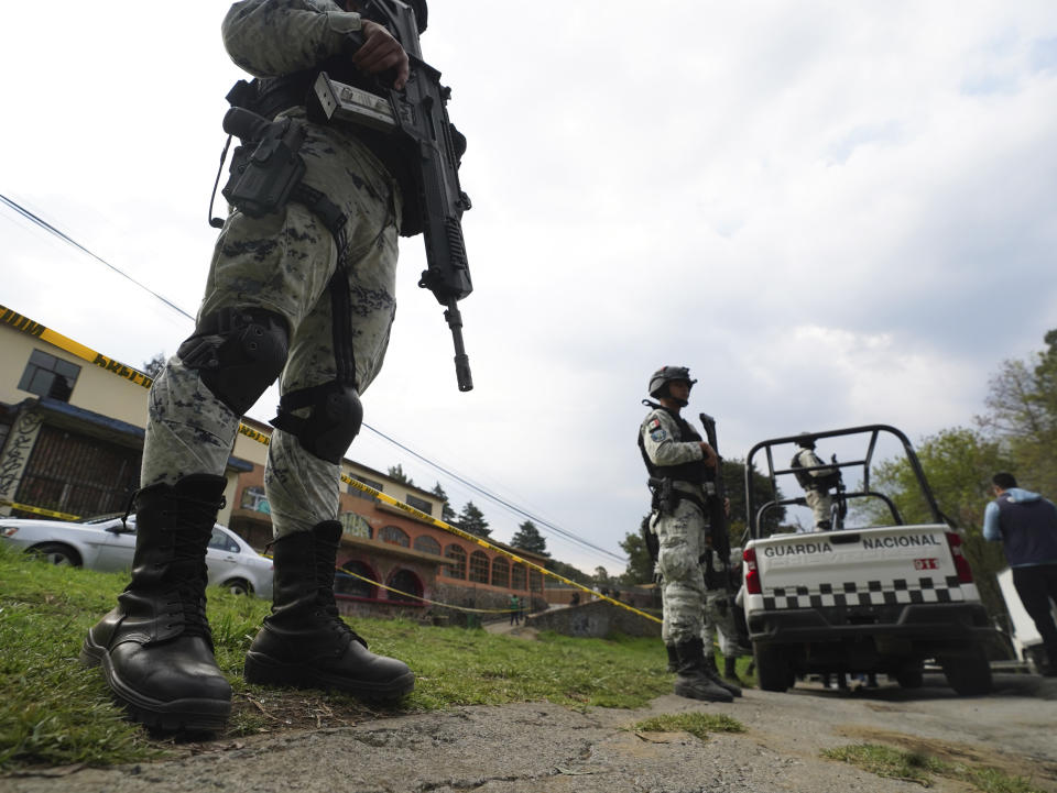 National Guardsmen guard the place where a confrontation took place with what authorities say were groups of criminals, that left several police officers wounded and more than a dozen people detained, in Tupilejo, on the outskirts of Mexico City, on Tuesday, March 12. July 2022. (AP Photo/ Marco Ugarte)