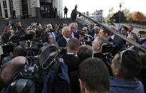 Attorney Joe Rice, center, speaks to the media outside the U.S. Federal courthouse, Monday, Oct. 21, 2019, in Cleveland. The nation's three dominant drug distributors and a big drugmaker have reached a $260 million deal to settle a lawsuit related to the opioid crisis just as the first federal trial over the crisis was due to begin Monday. (AP Photo/Tony Dejak)