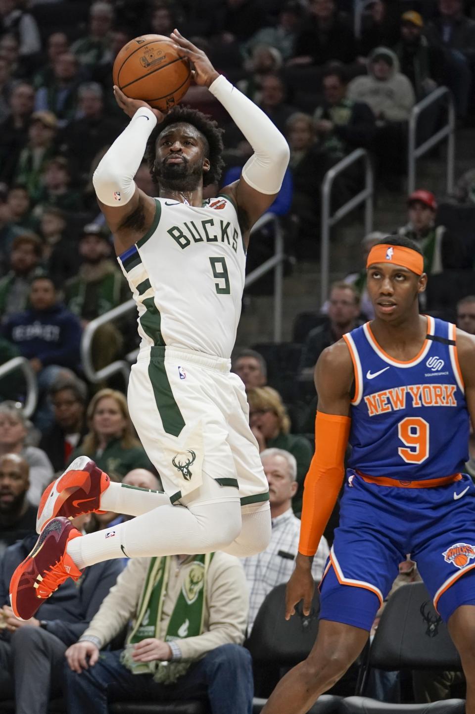 Milwaukee Bucks' Wesley Matthews shoots over New York Knicks' RJ Barrett during the second half of an NBA basketball game Tuesday, Jan. 14, 2020, in Milwaukee. (AP Photo/Morry Gash)