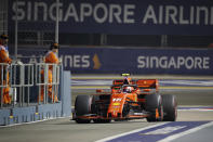 Ferrari driver Charles Leclerc of Monaco steers his car into pit-lane during the second practice session at the Marina Bay City Circuit ahead of the Singapore Formula One Grand Prix in Singapore, Friday, Sept. 20, 2019. (AP Photo/Vincent Thian)