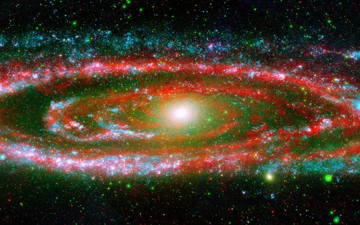  The many personalities of our great galactic neighbor, the Andromeda galaxy, are exposed in this composite image from NASA's Galaxy Evolution Explorer and the Spitzer Space Telescope. 