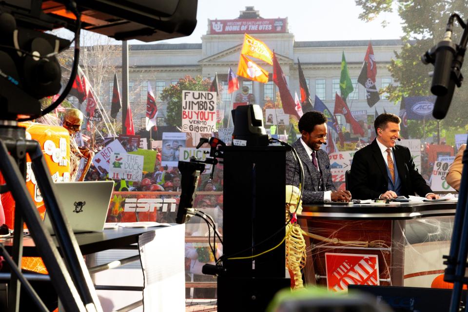 Utah fans cheer and wave flags in the background while Desmond Howard, left, and host Rece Davis talk during the filming of ESPN’s “College GameDay” show at the University of Utah in Salt Lake City on Saturday, Oct. 28, 2023. | Megan Nielsen, Deseret News