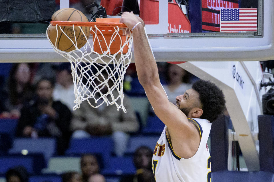 Denver Nuggets guard Jamal Murray dunks against the New Orleans Pelicans during the first half of an NBA basketball game in New Orleans, Tuesday, Jan. 24, 2023. (AP Photo/Matthew Hinton)