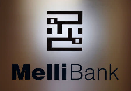 FILE PHOTO: A company logo of Bank Melli is displayed on the glass door at its branch in Hong Kong, China, August 8, 2012. REUTERS/Bobby Yip/File Photo