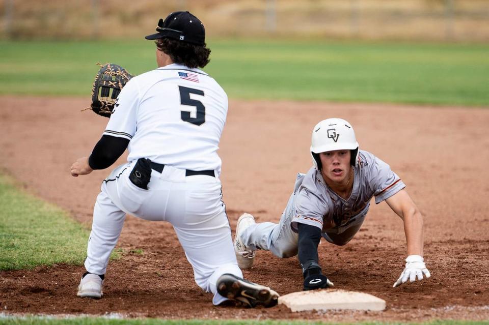 Golden Valley junior Koen Heupel (6) dives back to first base on a Buhach Colony pickoff attempt during a game at Buhach Colony High School in Atwater, Calif., on Thursday, May 4, 2023.