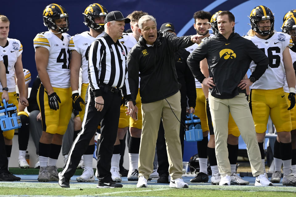 Iowa head coach Kirk Ferentz talks with an official in the first half of the Music City Bowl NCAA college football game against Kentucky, Saturday, Dec. 31, 2022, in Nashville, Tenn. (AP Photo/Mark Zaleski)