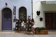 Women pose for pictures at the replica of Austria's UNESCO heritage site, Hallstatt village, in China's southern city of Huizhou in Guangdong province, June 1, 2012.