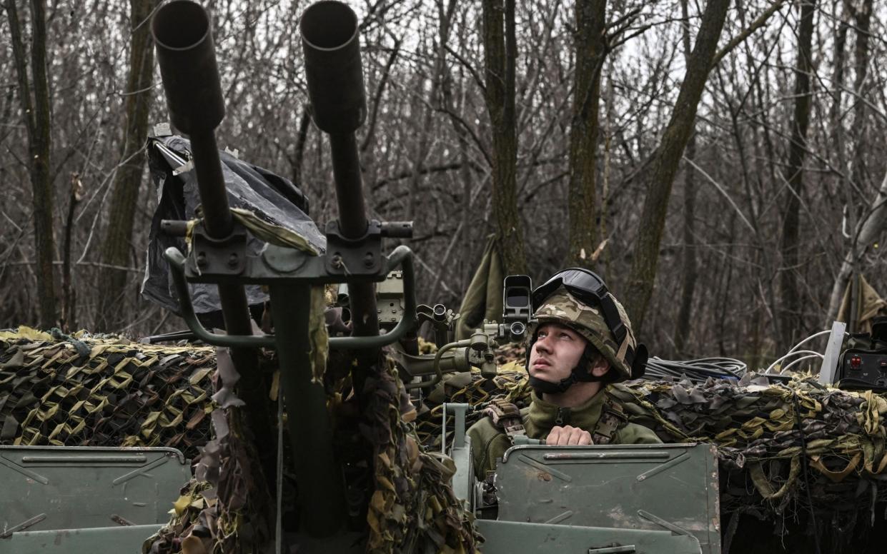 A Ukrainian serviceman looks on as he sits on an anti-air gun near Bakhmut, on March 24, 2023. (Photo by Aris Messinis / AFP) (Photo by ARIS MESSINIS/AFP via Getty Images) - ARIS MESSINIS/AFP via Getty Images