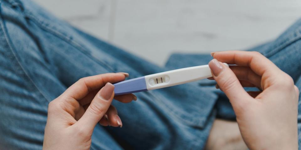 woman with positive pregnancy test