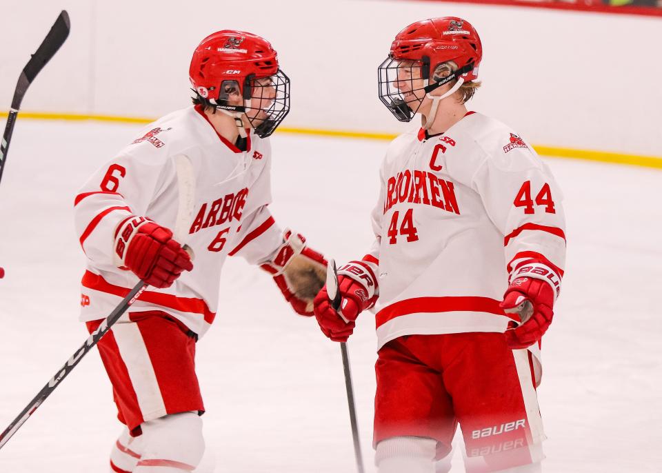 Hingham's Paul Dzavik, right, celebrates a goal with Travis Rugg during a game against Duxbury at Pilgrim Skating Arena in Hingham on Monday, January 29, 2024.