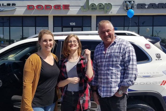 Strive to Drive winner Kayla Torango picks up her new Jeep Cherokee from Columbia Chrysler Dodge Jeep Ram Fiat owner Eddie Collier, left, and customer specialist Brittany Sloan, right.