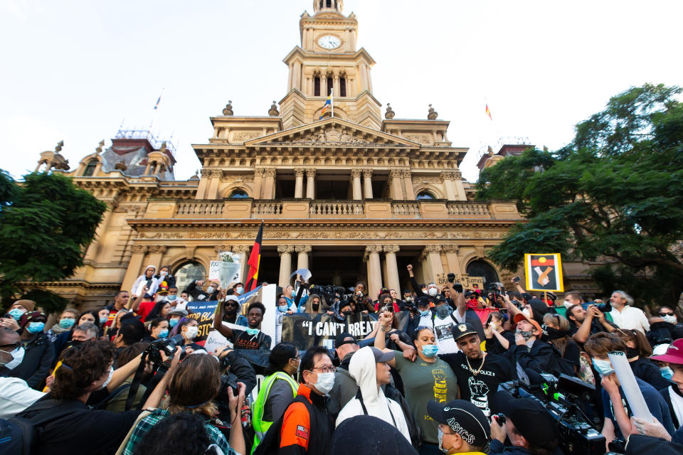 SYDNEY, AUSTRALIA - JUNE 06: People protest and hold up signs at rally outside Sydney Town Hall on 06 June, 2020 in Sydney, Australia. This event was organised to rally against black deaths in custody in Australia as well as a vigil for George Floyd, an unarmed black man killed at the hands of a police officer in Minneapolis, Minnesota and David Dungay who died in custody at Long Bay prison in Sydney. (Photo by Speed Media/Icon Sportswire)