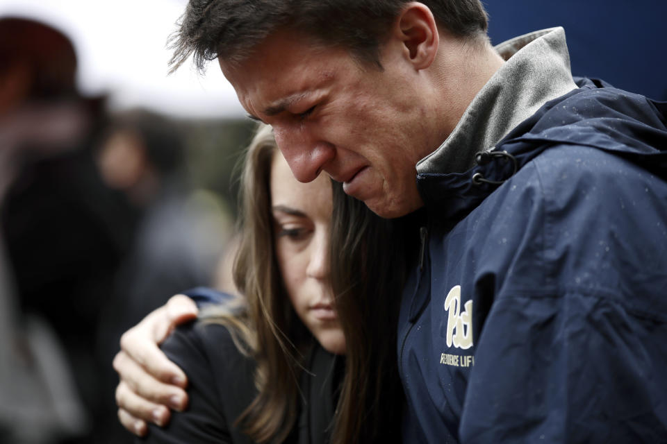 People gather outside the Soldiers & Sailors Memorial Hall & Museum, Sunday, Oct. 28, 2018, in Pittsburgh, during a community gathering in the aftermath of the deadly shooting at the Tree of Life Synagogue a day earlier. (AP Photo/Matt Rourke)