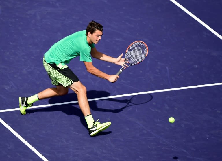 Taylor Fritz hits a backhand volley in his straight set victory over Benoit Paire of France at Indian Wells Tennis Garden