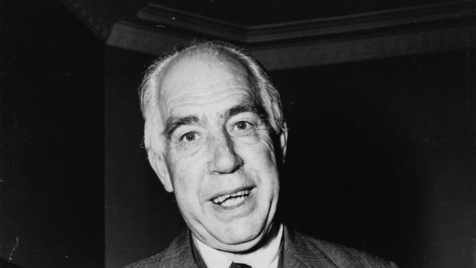 niels bohr smiling while wearing a suit for a photograph