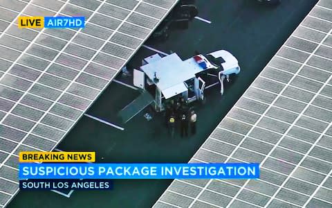 Federal and city investigators at the scene of a reported suspicious package at a U.S. Postal Service mail facility in South Los Angeles - Credit: KABC-TV /AP