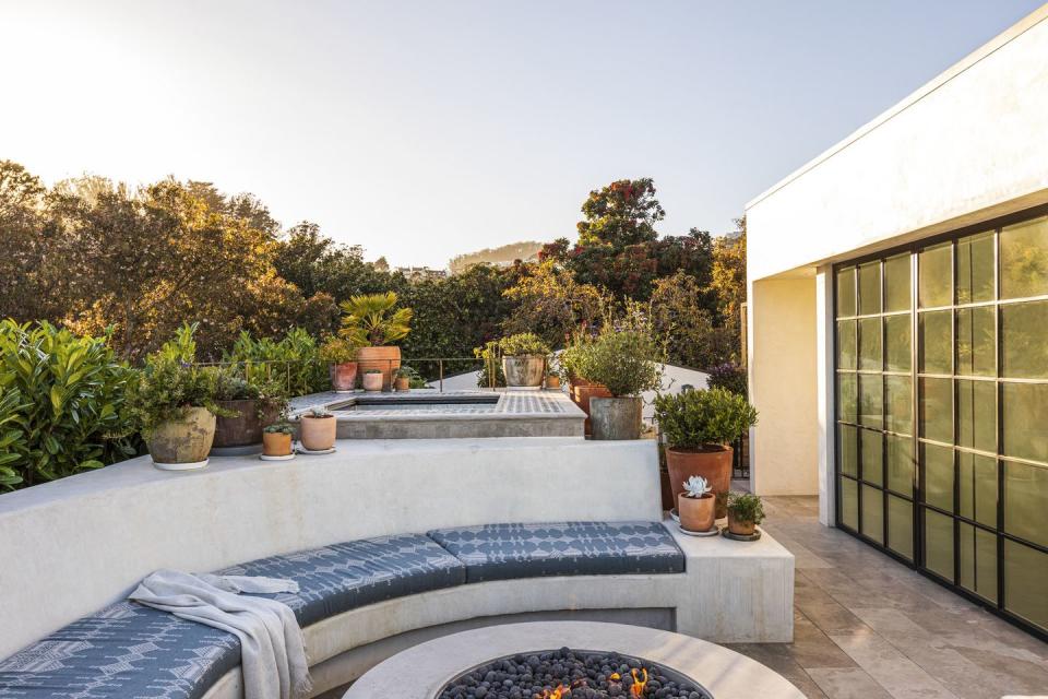 1920s spanish colonial in san francisco designed by regan baker design and landscape architect terremoto roof deck all three firms, medium plenty, terremoto, and regan baker interiors, came together to mastermind this bonus entertaining space, complete with a hot tub, fire pit, and herb garden bench cushions jovinas upholstery, in peter dunham textiles fabric flooring custom marble, stone fleury