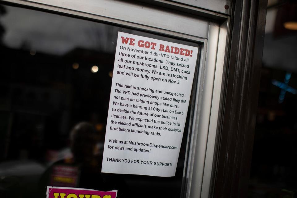 A sign outside Larsen's mushroom dispensary store tells customers police raided the store on Wednesday, and it will reopen on Friday.