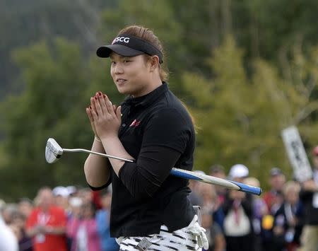 Aug 28, 2016; Calgary, Alberta, CAN; Ariya Jutanugarn of Thailand reacts after sinking her putt on the 18th green during the final round of the Canadian Pacific Women's Open at Priddis Greens Golf and Country Club. Mandatory Credit: Eric Bolte-USA TODAY Sports