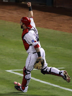 Rangers catcher Mike Napoli pumps a fist after throwing the ball to first base to record the final out of Game 5 of the World Series