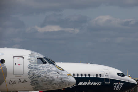 FILE PHOTO: A Boeing 737 MAX and an Embraer E190-E2 are seen on the static display, before the opening of the 52nd Paris Air Show at Le Bourget airport near Paris, France, June 16, 2017. REUTERS/Pascal Rossignol/File Photo