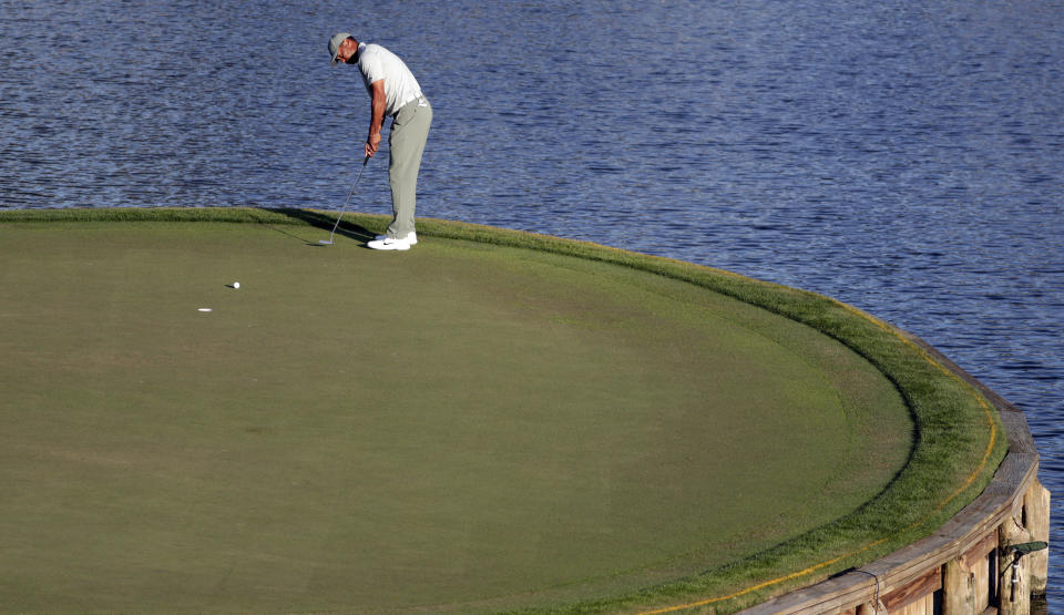 Tiger Woods putts on the 17th green during the first round of The Players Championship golf tournament Thursday, March 14, 2019, in Ponte Vedra Beach, Fla. (AP Photo/Lynne Sladky)