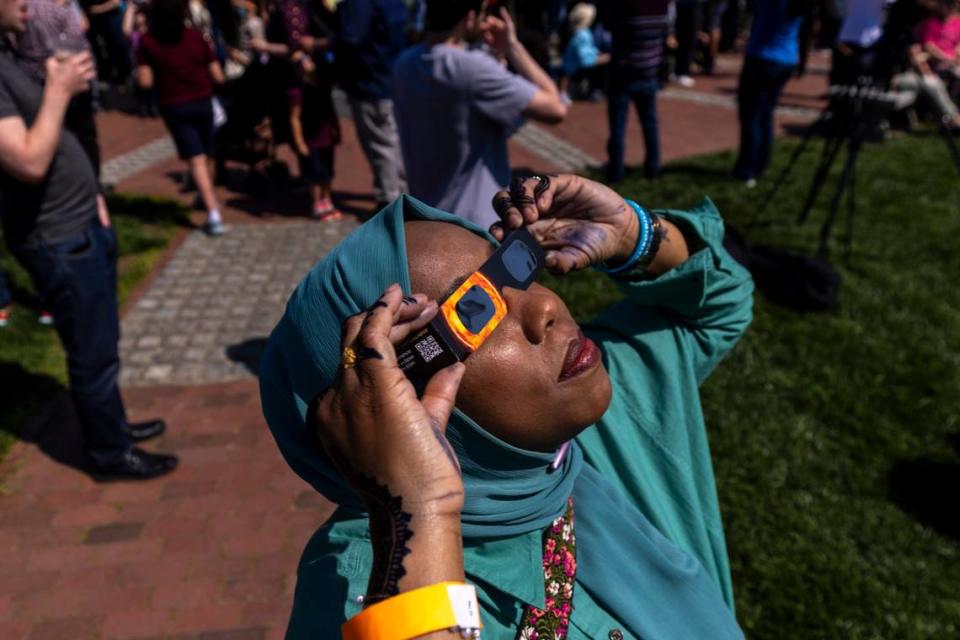 Paris Miller-Foushee wears protective glasses while viewing the solar eclipse during a watch party at the Morehead Planetarium and Science Center at UNC-Chapel Hill on Monday, April 8, 2024. Travis Long/tlong@newsobserver.com