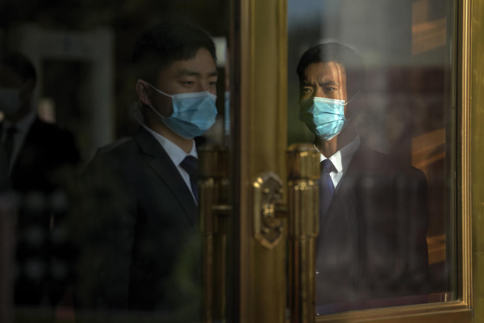 Soldiers dressed as ushers stand guard at an entrance door of the Great Hall of the People as they prepare for the arrival of the foreign leaders to attend the opening ceremony of the Belt and Road Forum in Beijing, Wednesday, Oct. 18, 2023. (AP Photo/Ng Han Guan)