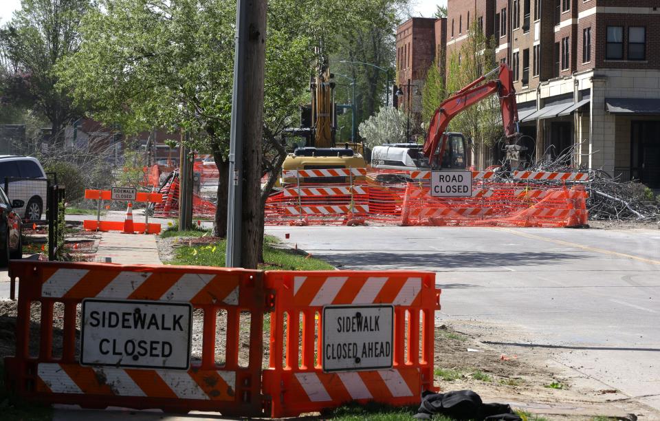 Signs warn residents of closed streets and sidewalks as crews work on the Gilbert Street bridge Thursday, April 25, 2024 in downtown Iowa City, Iowa.