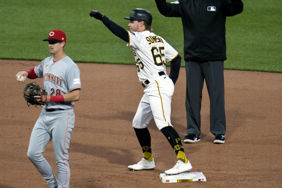 Pittsburgh Pirates' Jack Suwinski (65) celebrates as he stands on second base after driving in a run with a double off Cincinnati Reds starting pitcher Luis Cessa during the fourth inning of a baseball game in Pittsburgh, Saturday, April 22, 2023. (AP Photo/Gene J. Puskar)