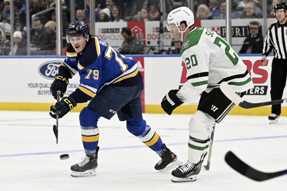 St. Louis Blues' Sammy Blais (79) passes the puck against Dallas Stars' Ryan Suter (20) during the second period of an NHL hockey game Wednesday, Dec. 27, 2023, in St. Louis. (AP Photo/Michael Thomas)