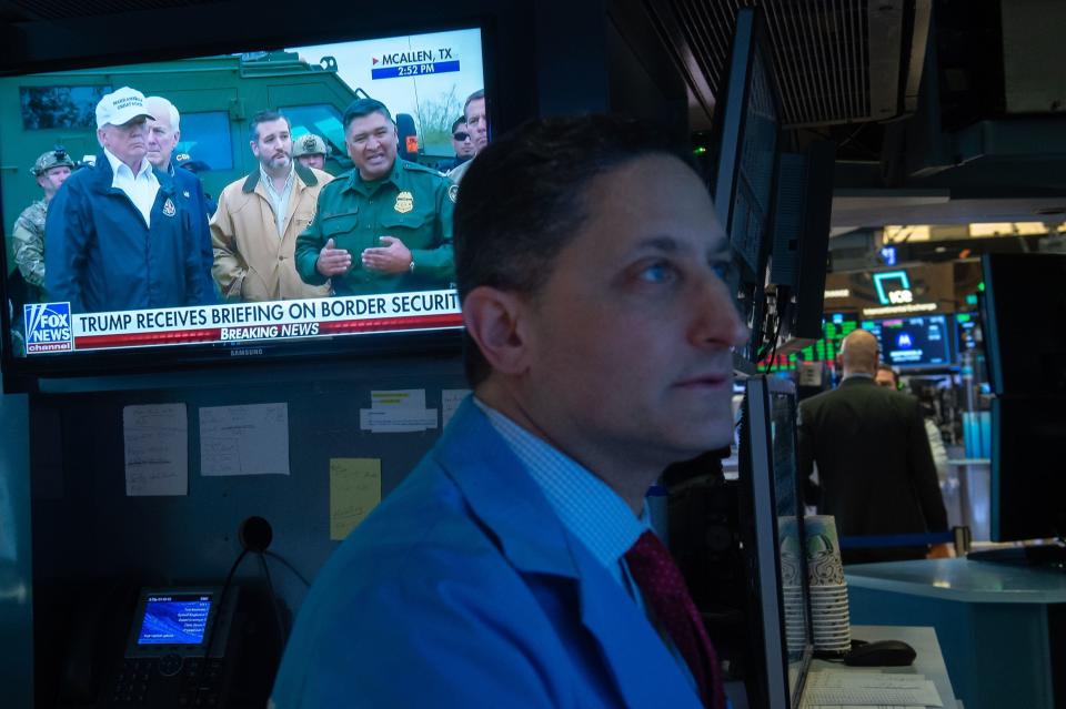 President Donald Trump is televised discussing the southern border wall as traders work on the floor at closing bell of the Dow Industrial Average at the New York Stock Exchange on January 10, 2019 in New York. - Wall Street stocks rose for a fifth straight session on Thursday, overcoming disappointing holiday sales from Macy's and other retailers following a day of choppy trade.The Dow Jones Industrial Average finished up 0.5 percent at 24,000.76.The broad-based S&P 500 also gained 0.5 percent to 2,596.59, while the tech-rich Nasdaq Composite Index advanced 0.4 percent to 6,986.07. (Photo by Bryan R. Smith / AFP)        (Photo credit should read BRYAN R. SMITH/AFP/Getty Images)