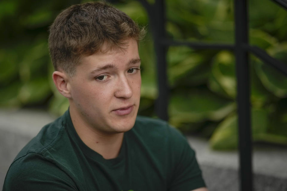 Matt Holden, a survivor of the 2012 Sandy Hook Elementary School shooting, talks about upcoming high school graduation, before a rally against gun violence on Friday, June 7, 2024, in Newtown, Conn. (AP Photo/Bryan Woolston)