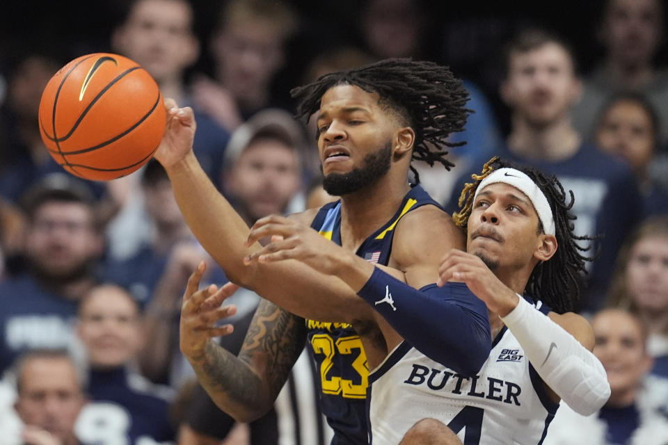 Marquette's David Joplin (23) and Butler's DJ Davis (4) vie for a rebound during the first half of an NCAA college basketball game Tuesday, Feb. 13, 2024, in Indianapolis. (AP Photo/Darron Cummings)