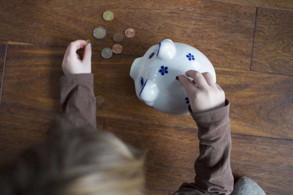 Bonn, Germany - February 03: Five-year old girl puts money in a money box on February 03, 2018 in Bonn, Germany. (Photo Illustration by Ute Grabowsky/Photothek via Getty Images)