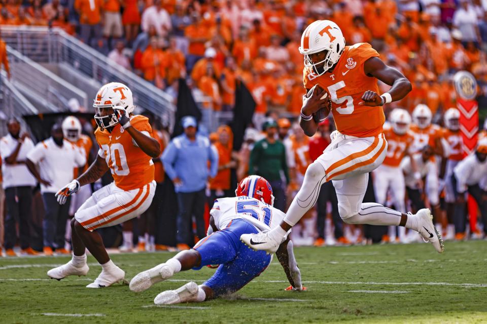 Tennessee quarterback Hendon Hooker (5) leaps over Florida linebacker Ventrell Miller (51) en route to a touchdown on Saturday, Sept. 24, 2022, in Knoxville, Tenn. (AP Photo/Wade Payne)