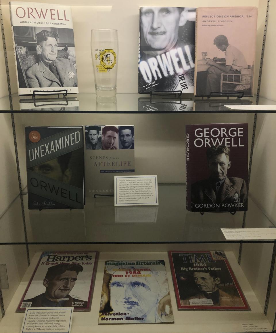 In this Oct. 21, 2019, photo, books and magazines about the novelist George Orwell are shown at an exhibit in Albuquerque, N.M. celebrating the author's legacy. The exhibit at the University of New Mexico is tackling the themes of the novelist's work from "1984" to "Animal Farm." "George Orwell: His Enduring Legacy," which runs to April 2020, features posters and material related to work challenging totalitarianism. (AP Photo/ Russell Contreras)