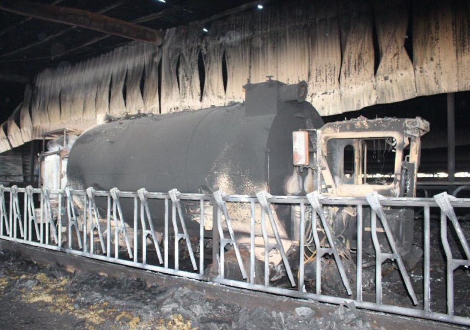 A photo from the State Fire Marshal's Office report shows the burnt-out manure vacuum truck, the cause of the fire.